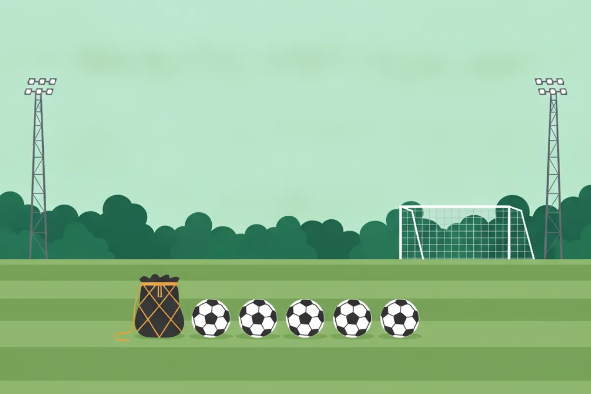 A row of five footballs beside a black ball bag with an amber drawstring on striped grass, a goal and trees beyond, and two tall floodlight towers at either side.