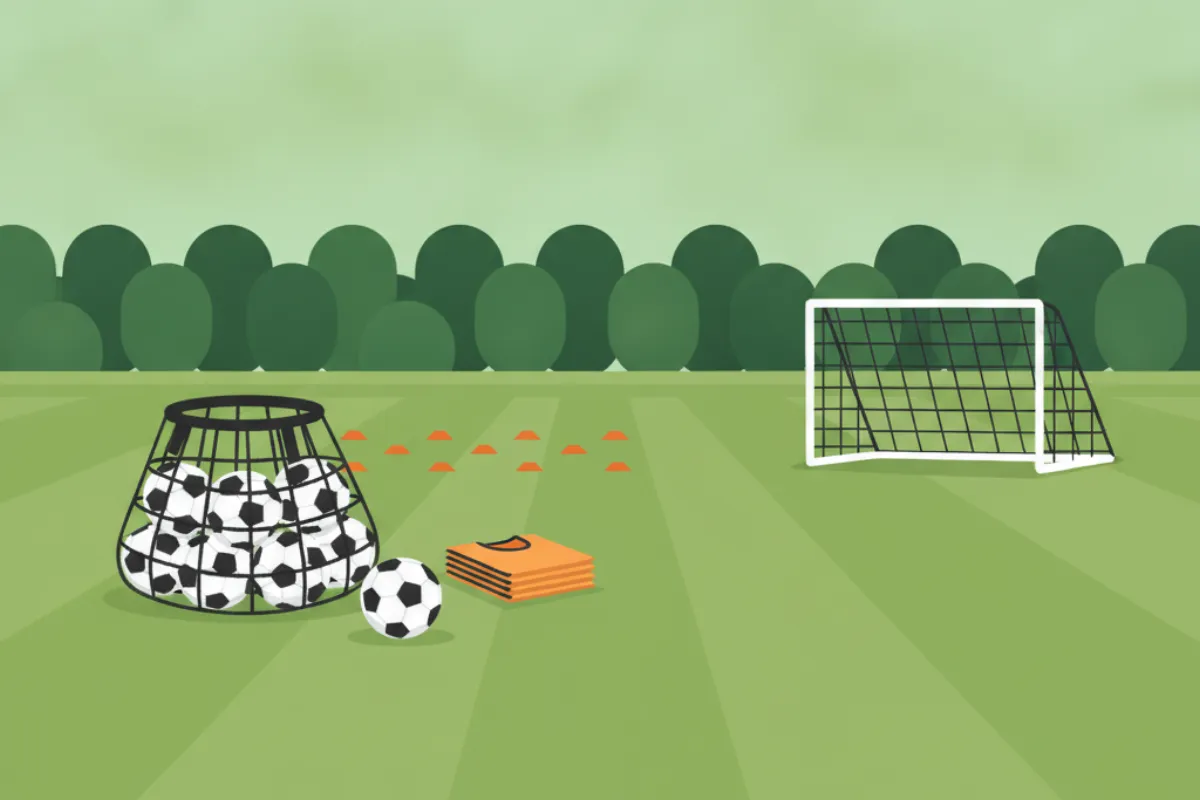 A mesh bag of footballs, a ball on the grass and a stack of amber training bibs, with a grid of marker cones and a small goal beyond on striped grass.